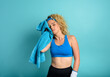 © alphaspirit - Woman does gym at home. tired expression. cyan background