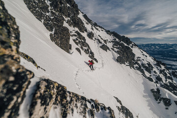 Wall Mural - An alpinist climbing in winter alpine like landscape of High Tatras, Slovakia. Winter mountaineering in snow, ice and rock. Alpinism, high peaks and summits with snow and ice.