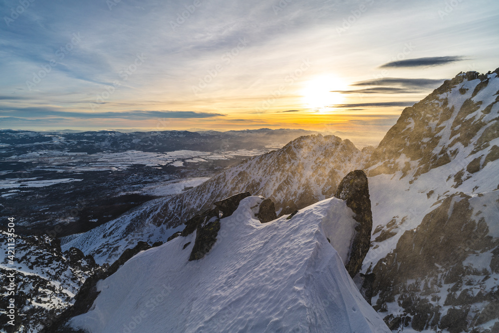 Sunset in winter alpine like mountain landscape of High Tatras, Slovakia. Snow covered mountains, high rocky faces and peaks during sunset. - obrazy, fototapety, plakaty 