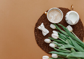 Canvas Print - Cup of coffee with bouquet of white tulips.Valentines, Mothers, Womens Day morning concept. Top view. Copy space, flat lay .