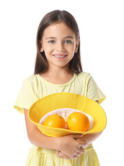 Wall Mural - Cute little girl with oranges on white background