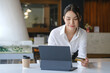 © Prathankarnpap - Attractive woman holding credit card and using computer tablet for online payment or online shopping.