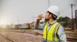 Caucasian man railway engineer drink water from bottle in the site work of train garage.