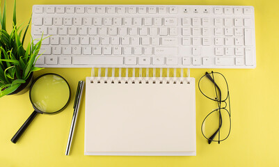 Poster - Office desk table Top view with keyboard and notebook copy space yellow background