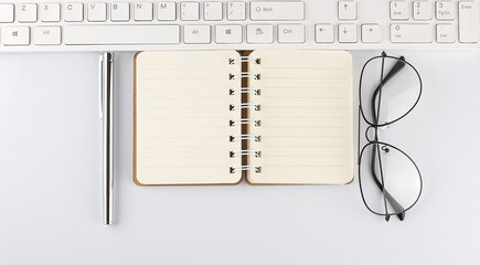 Poster - Black notebook and laptop keyboard, pen ,glassesand glasses on the white background, text space and copy