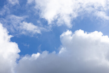 detail of a white cloud in a bright blue sky. dark rain clouds displace the blue sky. storm is comin