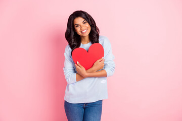 Wall Mural - Photo of positive romantic lady cuddle red paper heart card toothy smile wear blue sweater isolated pink background
