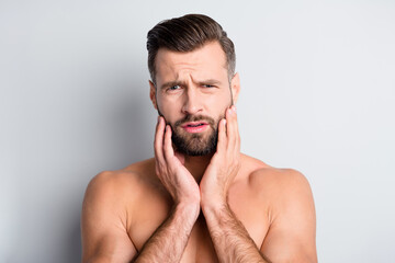 Sticker - Photo of young handsome man unhappy sad upset displeased problem hand touch beard isolated over grey color background