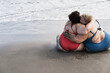 © DisobeyArt - Back view of plus size women sitting on the beach having fun during summer vacation - Focus on right face