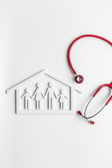 Wall Mural - Family figure in house frame with stethoscope. Medical care concept