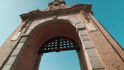 Sticker - Camera slider moves under Puente de Alcantara is Roman arch bridge in Toledo, Spain, spanning the Tagus River, blue clear sky during sunny day, no people. Travel destinations, landmark concept. Spain
