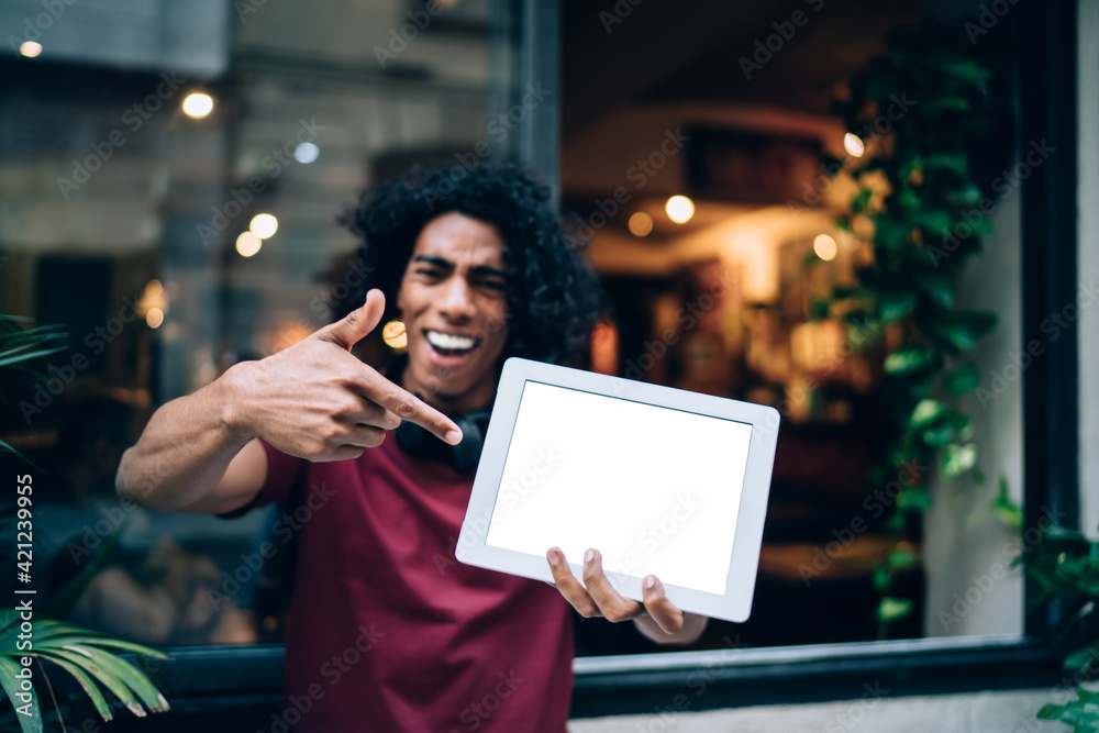 Millennial generation man with blank touch pad pointing on mock up screen display with copy space area for social publication with advertising, blurred male blogger showing gadget notification for app - obrazy, fototapety, plakaty 