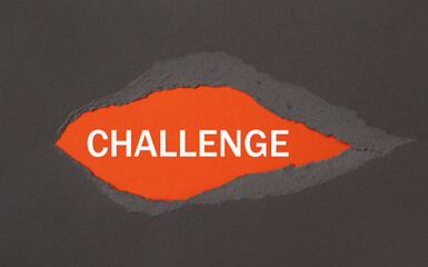 CHALLENGE - appearing behind torn paper.