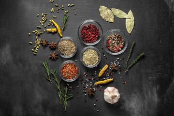 various spices on a gray background. seasoning in glass cups top view