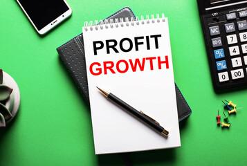Fototapete - On a green background - a telephone, a calculator and a diary with the inscription PROFIT GROWTH
