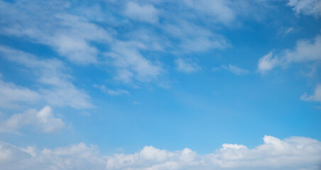 Wall Mural - blue sky with floating cumulus clouds and copy space