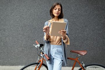 Wall Mural - Young business woman using a digital tablet computer outdoor city