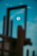 Close-up Of Frame Against Blue Sky And Full Moon
