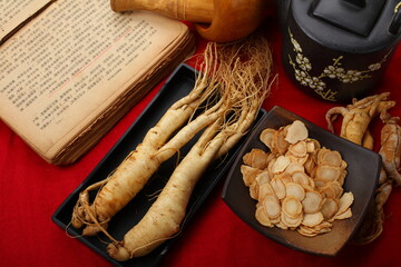 Fresh ginseng on red background.