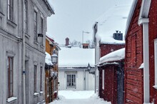 Snow Covered Houses Amidst Buildings In City