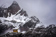 A Little Shed In Front Of Jade Dragon Snow Mountain Peak,snowcapped Mountain Agains Tge Sky