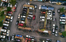 High Angle View Of Car Park By Buildings