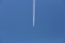 Low Angle View Of Airplane Flying Against Blue Sky