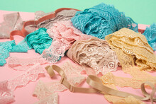 Pile Of Color Lace For Lingerie On Pink Background. Delicate Elastic Material.