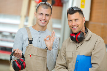 Wall Mural - apprentice with earmuffs with okay sign