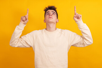 Poster - young teenage man pointing isolated on background