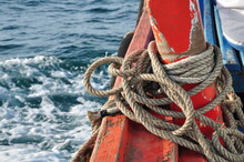 Close-up Of Rope Tied To Boat Moored In Sea