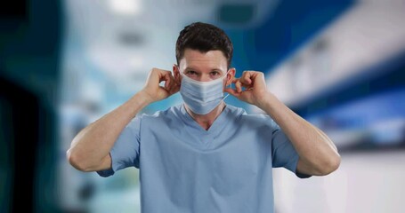 Canvas Print - Animation of male doctor putting face mask on over out of focus hospital