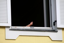 Low Angle View Of Foot In Window