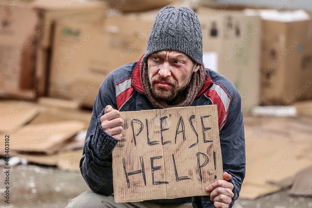 Poor homeless man begging for food outdoors on winter day - obrazy, fototapety, plakaty 