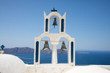 Bell Tower Against Seascape And Clear Blue Sky