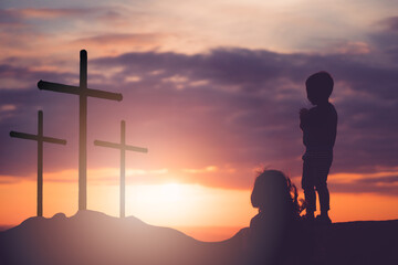 Wall Mural - He is risen.Jesus Christ cross and worship with faith in Good friday.Silhouette kid child pray in Easter, Good friday.jesus christ in holy cross on resurrection sunday. Worship jesus, christian, pray.