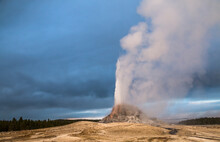 Dramatic Photo Of An Erupting Geyser In Yellowstone National  Park In Wyoming.