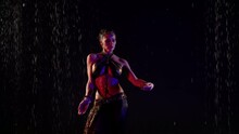 Sexy Busty Woman Is Dancing Belly Dance Under Rain, Wriggling Her Beautiful Body With Big Breasts