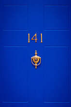 House Number 141 On A Blue Wooden Front Door