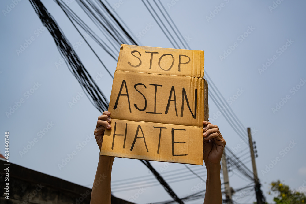 A man holding Stop Asian Hate sign - obrazy, fototapety, plakaty 