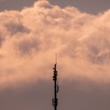 Telecommunications Mast In Front Of Clouds