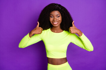 Sticker - Photo of young beautiful lovely smiling african girl showing thumb-up wear sports suit isolated on violet color background