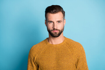 Poster - Photo of young handsome attractive serious man look camera wear yellow orange sweater isolated on blue color background