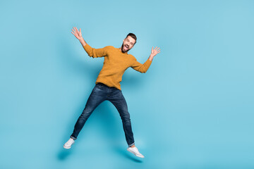 Wall Mural - Full length body size view of attractive cheerful carefree guy jumping fooling having fun isolated on bright blue color background