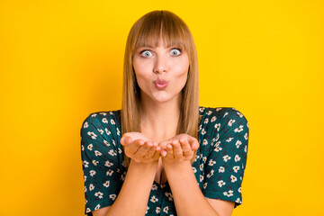 Poster - Portrait of charming cheerful blonde girl sending you air kiss isolated over bright yellow color background