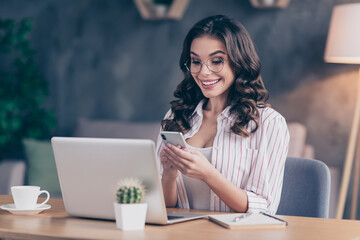 Canvas Print - Photo of funny pretty young lady wear white shirt spectacles typing modern gadget sitting table indoors inside room home