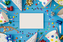Top View Photo Of Birthday Party Composition White Card With Copyspace In The Middle Spiral Tubes Ribbon Stars Candles Pipes Hats Confetti Paper Cups And Plates Isolated Blue Wooden Table Background