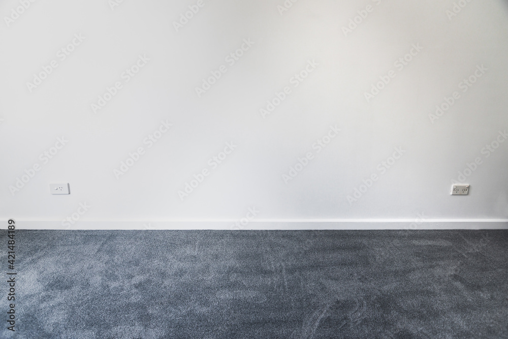 empty room with brand new grey blue carpet laid on the floor and freshly painted white walls, home renovation - obrazy, fototapety, plakaty 