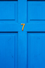 House Number 7 On A Blue Wooden Front Door In London