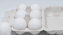 Cardboard Package With Chicken Eggs On White Surface